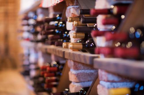 a bunch of wine bottles lined up on a wall at Hotel Triglav in Bled
