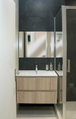 a bathroom with a sink and a mirror at Apart 1 opera · Modern studio fully furnished in Paris