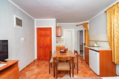 a living room with a table and a kitchen at Villa Glavanovic in Bar