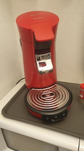 a red coffee maker sitting on top of a table at Le Galope, Appartement centre Compiègne in Compiègne