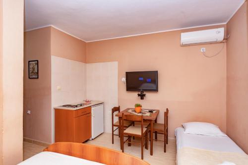 a small room with a table and a small kitchen at Villa Glavanovic in Bar