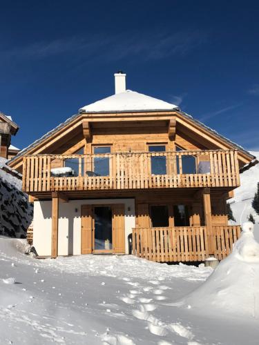 a wooden house in the snow with snow covered at Berghütte Murmele in Lachtal