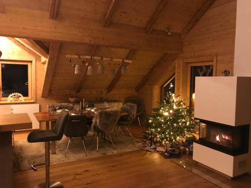a christmas tree in a living room with a fireplace at Berghütte Murmele in Lachtal