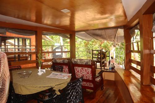 a dining room with a table and chairs at Kera Houseboats Alleppey in Alleppey