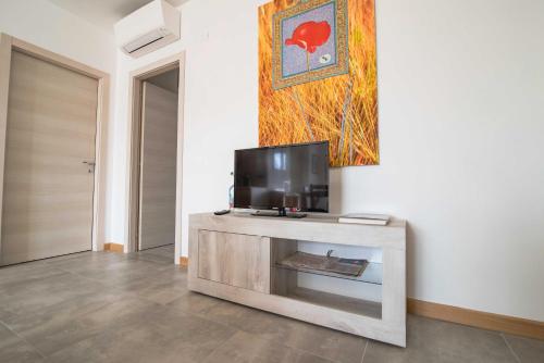 a living room with a flat screen tv on a table at Agricola Domus in Barolo