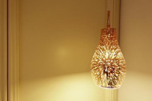 a light bulb hanging from a wall at Hotel U Kříže in Prague