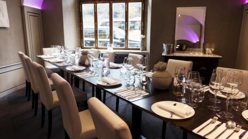 a dining room with a long table and chairs at Hotel U Kříže in Prague