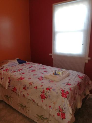 a bed with a tray on it in a room with a window at 5430 Happy Home in Chicago
