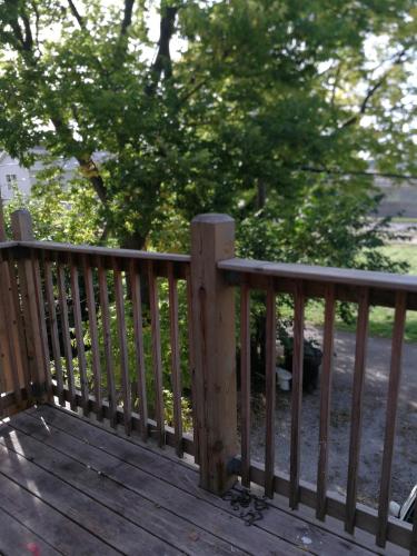 a wooden railing on a deck with trees in the background at 5430 Happy Home in Chicago