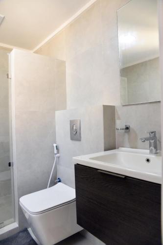 a bathroom with a tub and a toilet and a sink at salmiya - Amman -Family only in Kuwait
