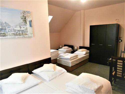 Postel nebo postele na pokoji v ubytování Sum Restauracja & Hotel