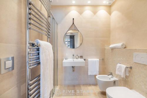 a bathroom with a sink and a toilet and a mirror at Villa Artemys - Five Stars Holiday House in Saint-Jean-Cap-Ferrat