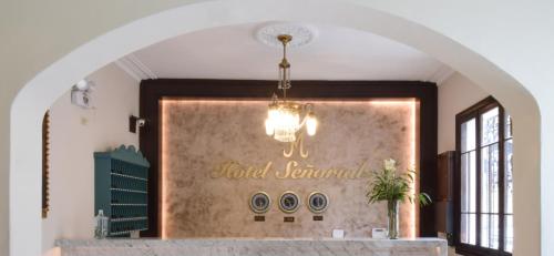 a chandelier hanging over a counter in a room at Hotel Señorial in Lima