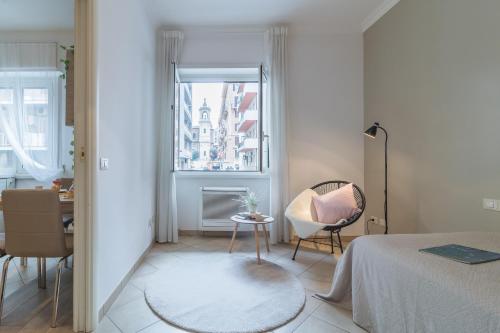 a bedroom with a bed and a chair and a window at Vaticano San Pietro Apartment in Rome