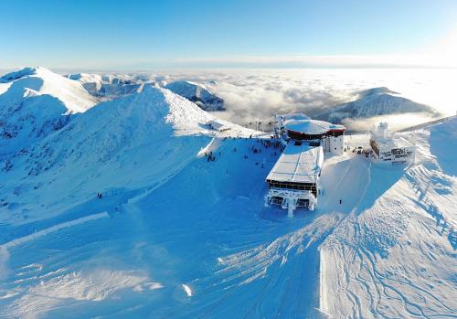 an observatory on top of a snow covered mountain at Chata 107 Tatralandia Village in Liptovský Mikuláš