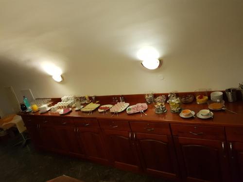 a counter with many plates and dishes on it at Městský Hotel Dorinka in Hostinné