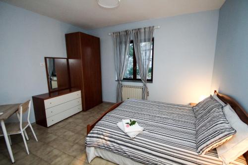 a bedroom with a bed and a dresser and a window at AceroRosso B&B in Salerno