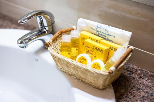 a basket of toiletries is sitting on a sink at Ganz SKI Lift 5 in Bukovel