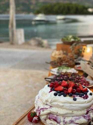 a row of cakes with strawberries and blueberries on them at Tara's Lodge in Korčula