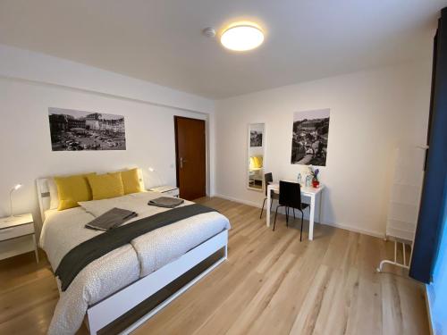 a bedroom with a bed and a desk in it at Park City Center in Luxembourg