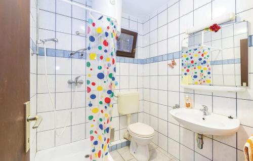 a bathroom with a toilet and a sink at Apartmani Jadra in Stara Novalja