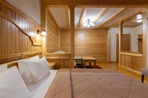 a bedroom with a bed in a room with wooden walls at Ganz SKI Lift 5 in Bukovel