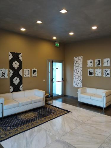 a lobby with two white couches in a room at Residence San Marino in San Marino