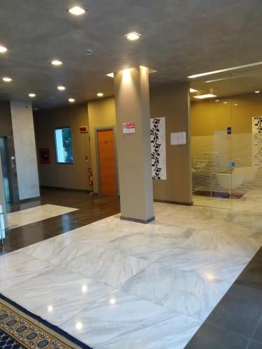a lobby with a large marble floor and a glass door at Residence San Marino in San Marino