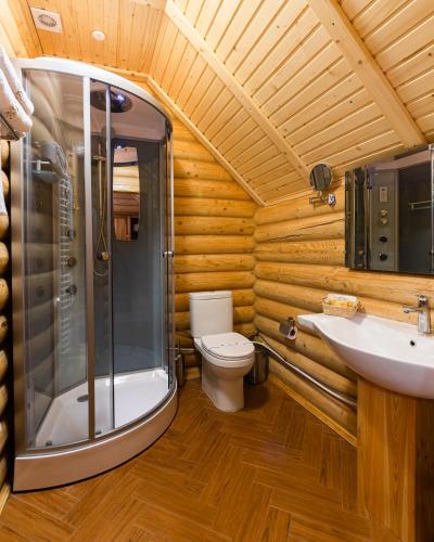a bathroom with a shower and a toilet and a sink at Ganz SKI Lift 5 in Bukovel