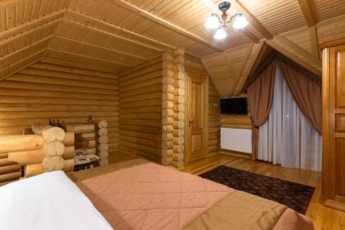 a bedroom with a bed in a wooden room at Ganz SKI Lift 5 in Bukovel