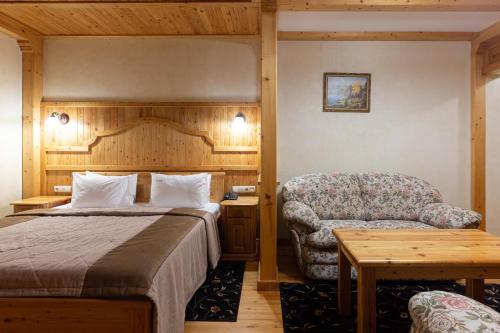 a hotel room with a bed and a chair at Ganz SKI Lift 5 in Bukovel