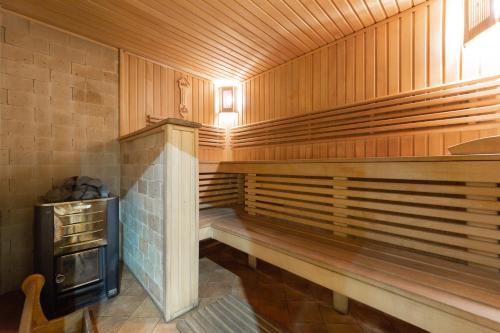 a sauna with wooden walls and a stove at Ganz SKI Lift 5 in Bukovel