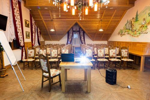 a room with a long table and chairs in it at Ganz SKI Lift 5 in Bukovel