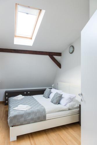 a bedroom with a bed and a window at Comfy loft on Hlavna in Košice