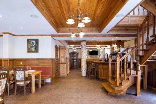 a dining room with wooden ceilings and a staircase at Ganz SKI Lift 5 in Bukovel