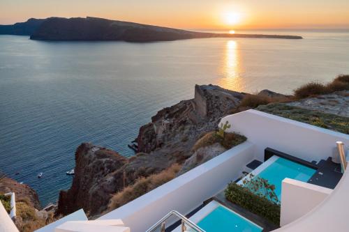 a house on the cliff with a view of the ocean at Marizan Caves & Villas in Oia