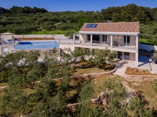 an aerial view of a house with a swimming pool at The Olive Tree Villa in Sumartin