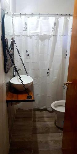 a bathroom with a sink and a toilet at Mi Jardín in San Rafael