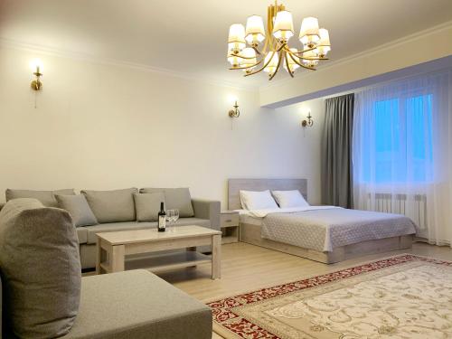 a living room with a bed and a couch at Brand new comfortable apartments in Sevan city in Sevan