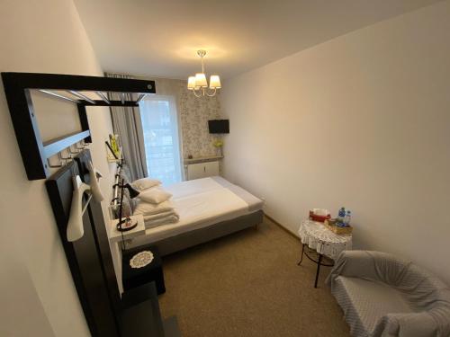 Ένα ή περισσότερα κρεβάτια σε δωμάτιο στο Kolorowa Guest Rooms