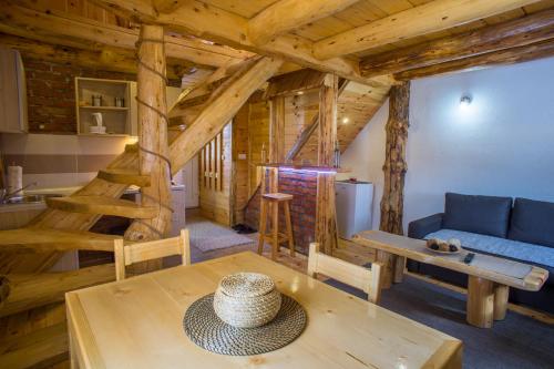 a living room with a table and a blue couch at Durmitorske zore in Žabljak