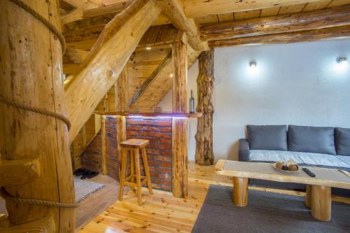 a living room with a blue couch and a table at Durmitorske zore in Žabljak
