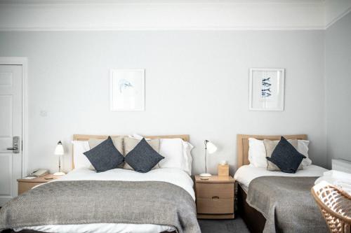 sypialnia z 2 łóżkami i poduszkami w obiekcie Dukes Inn w mieście Sidmouth
