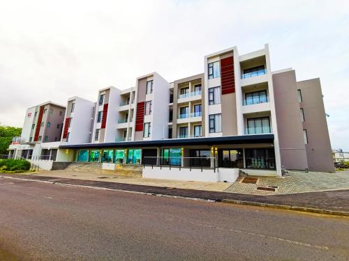 a large building on the side of a street at Avya's Studio 113 at Ebene Square, Ebene in Ebene