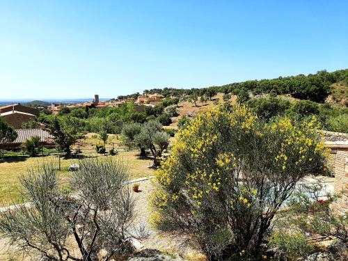 a view of a field with trees and houses at Can Santalo in Cantallops