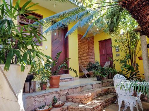 a yellow house with plants and a stone staircase at Pousada Solar Azul in Lençóis