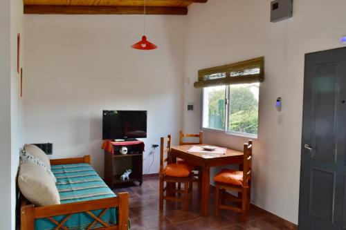 a living room with a table and chairs and a television at View Point Apart Nogal in Villa Giardino