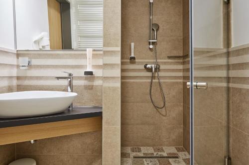 a bathroom with a sink and a shower at Gold House Pension in Balatonfüred