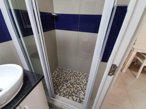 a shower with a glass door in a bathroom at The Zion Hill in East London