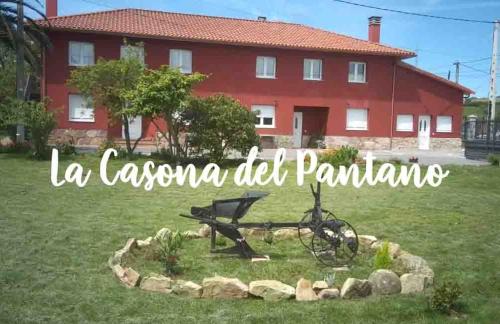 a red house with a bike in the yard at La casona del Pantano in Los Campos